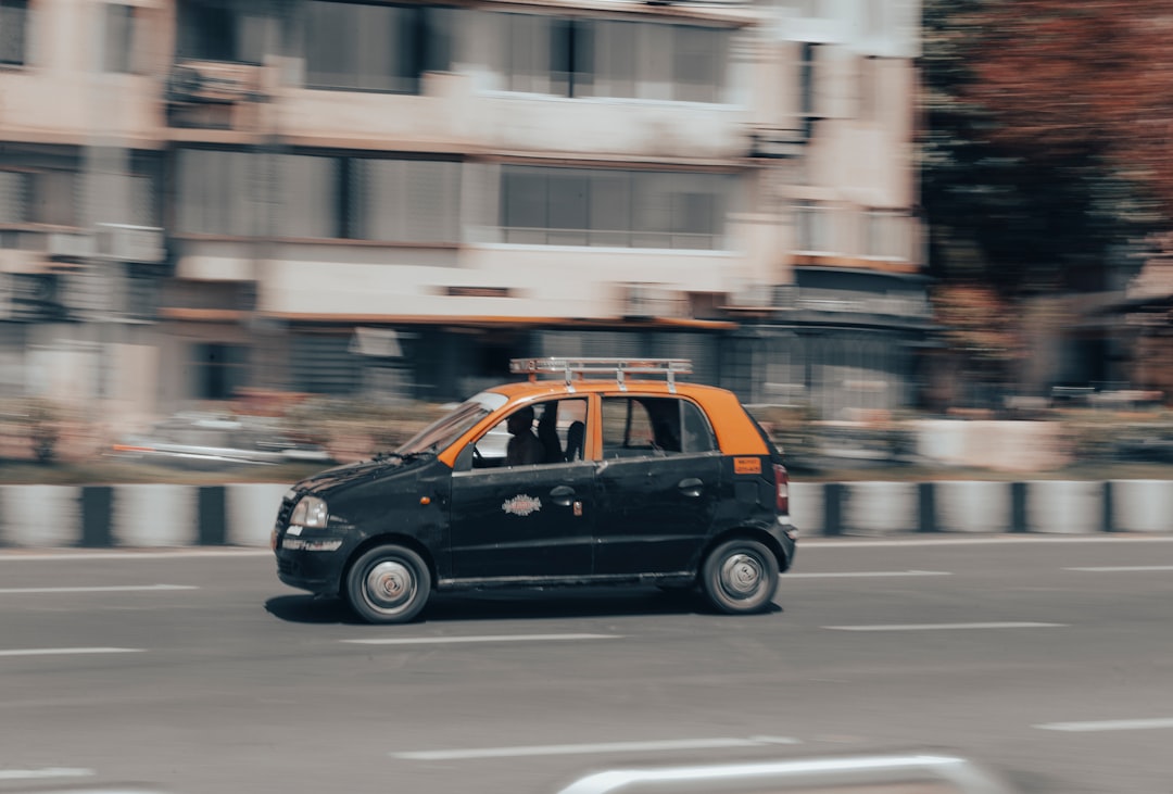 a small black car on a road